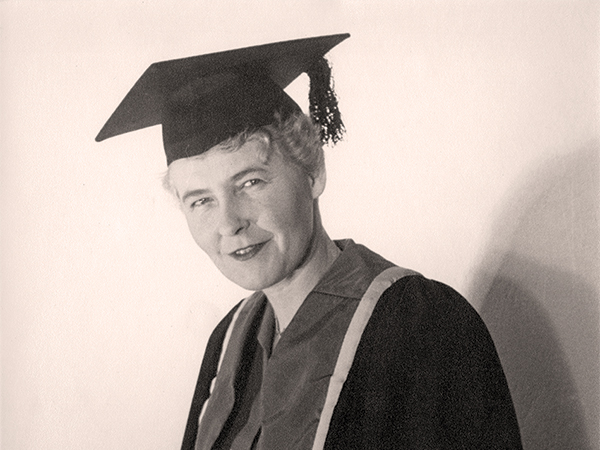 Dr. Elinor Frances Elizabeth Black posing in her Graduation Gown.