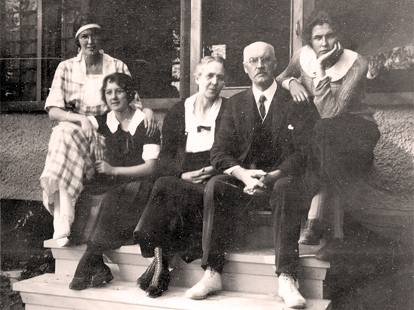 Five members of the Black family sitting on stairs.